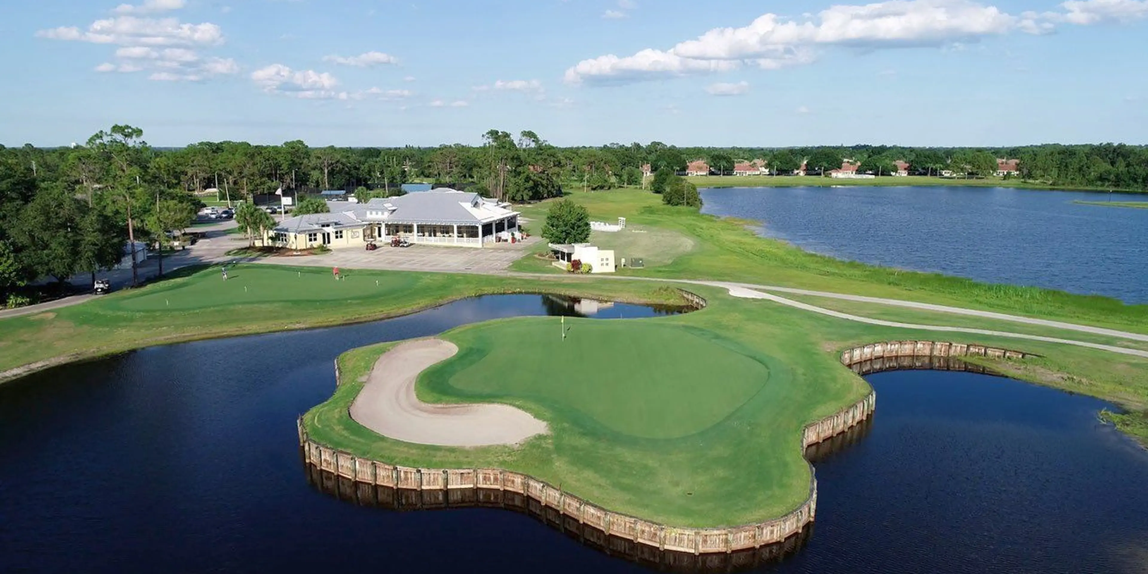 Landscape putting greens and fairway photo of the Sun 'N Lake Golf Club golf course