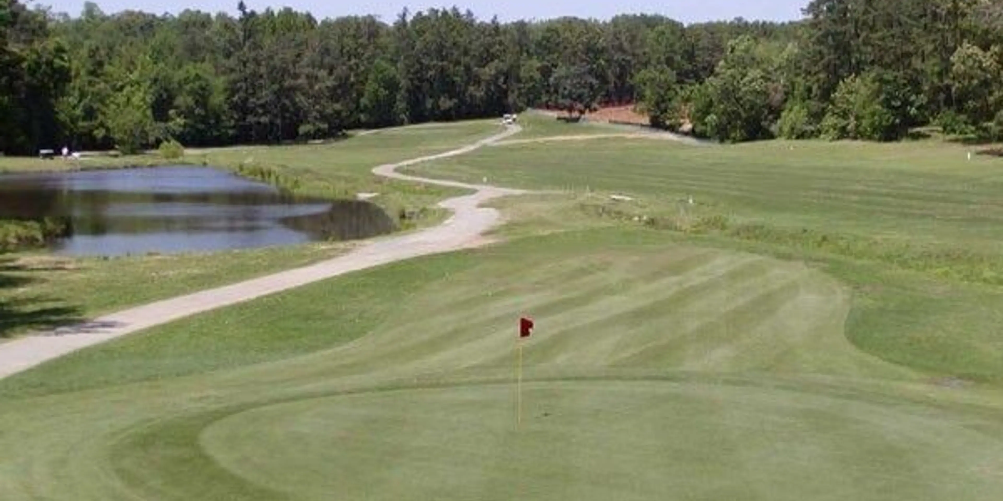 Landscape putting greens and fairway photo of the Sunset Hills Golf Course golf course