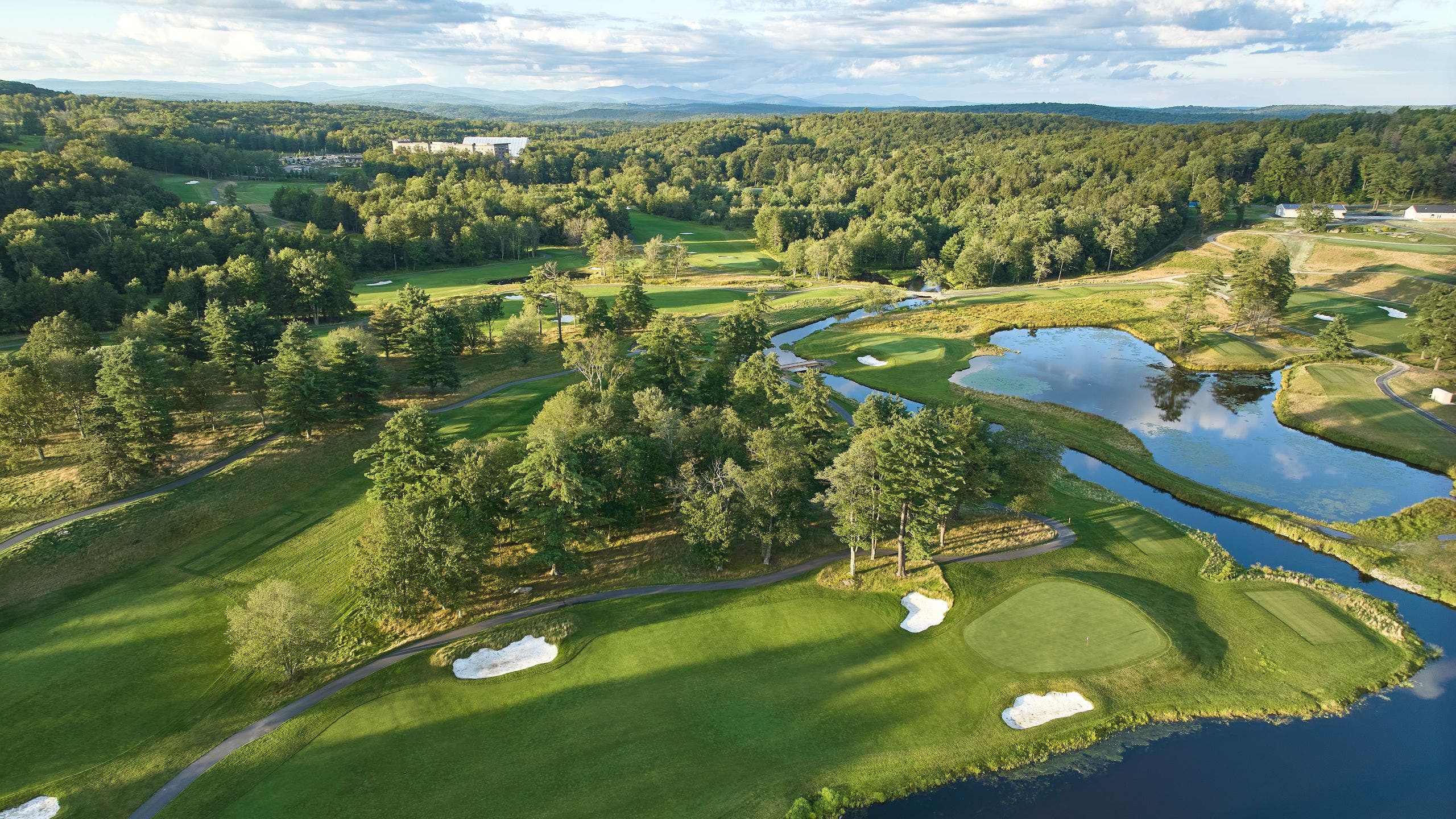 Landscape putting greens and fairway photo of the The Monster Golf Club golf course