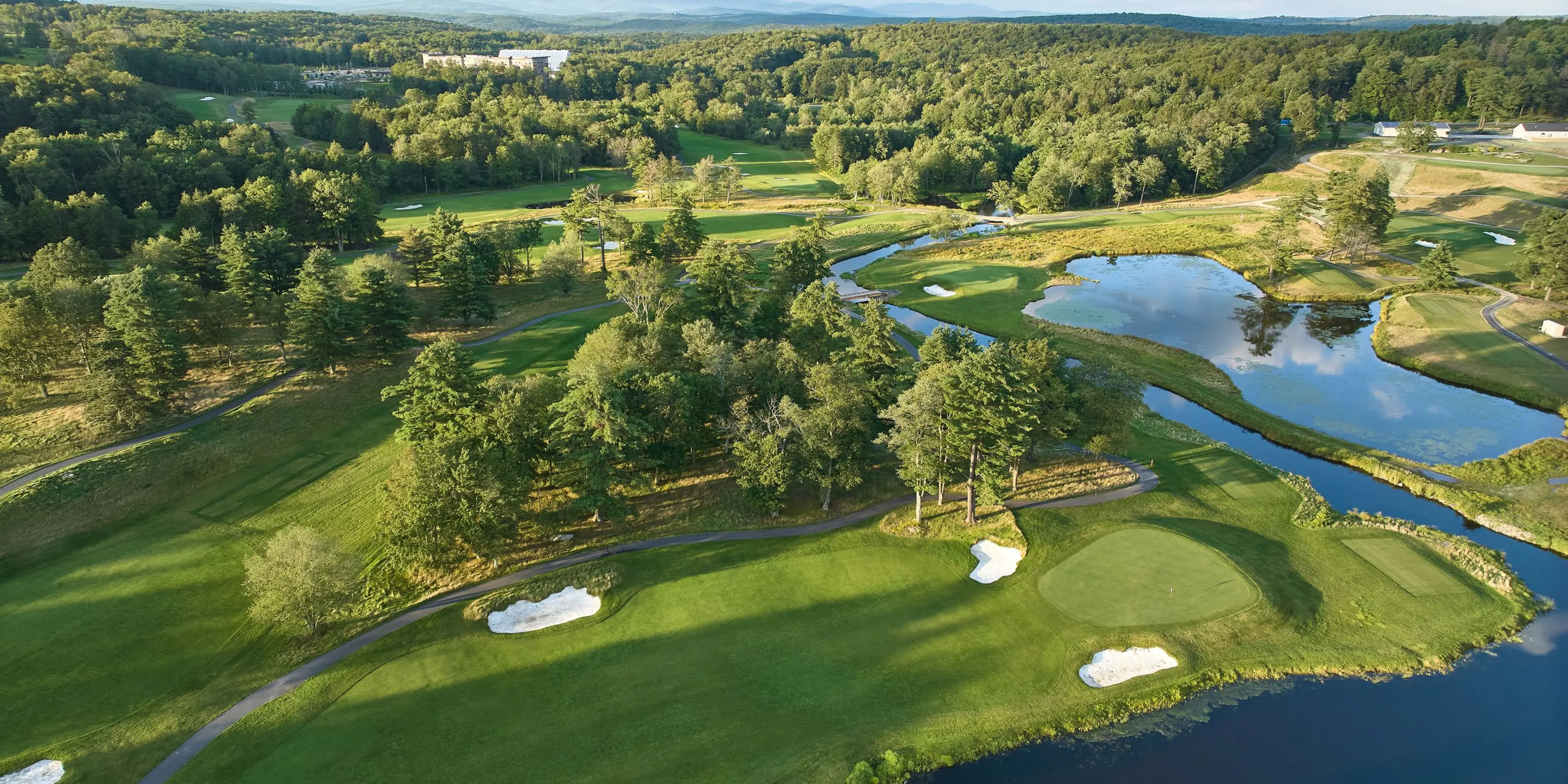 Landscape putting greens and fairway photo of the The Monster Golf Club golf course