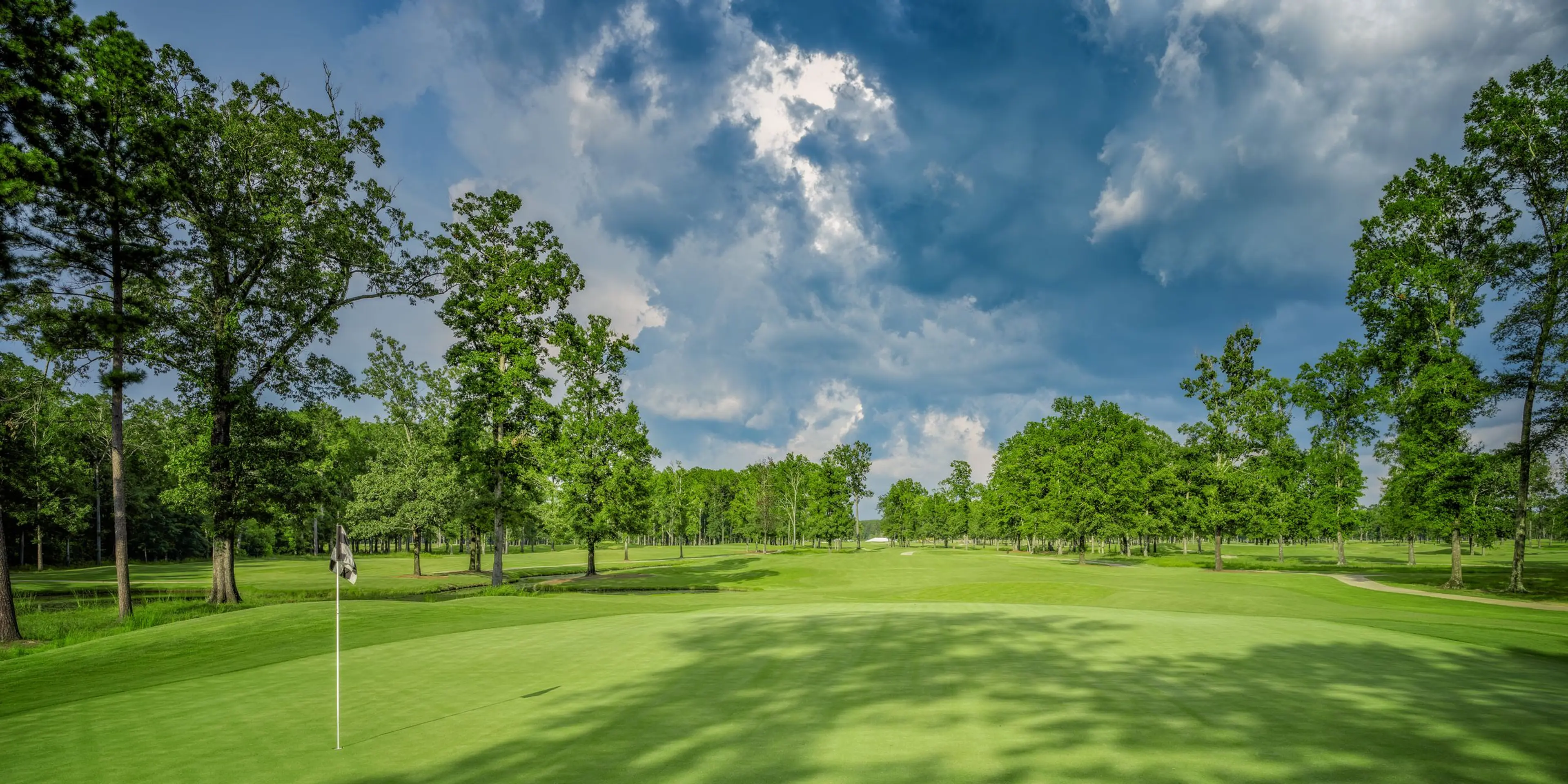 Landscape putting greens and fairway photo of the The Refuge Golf Course golf course