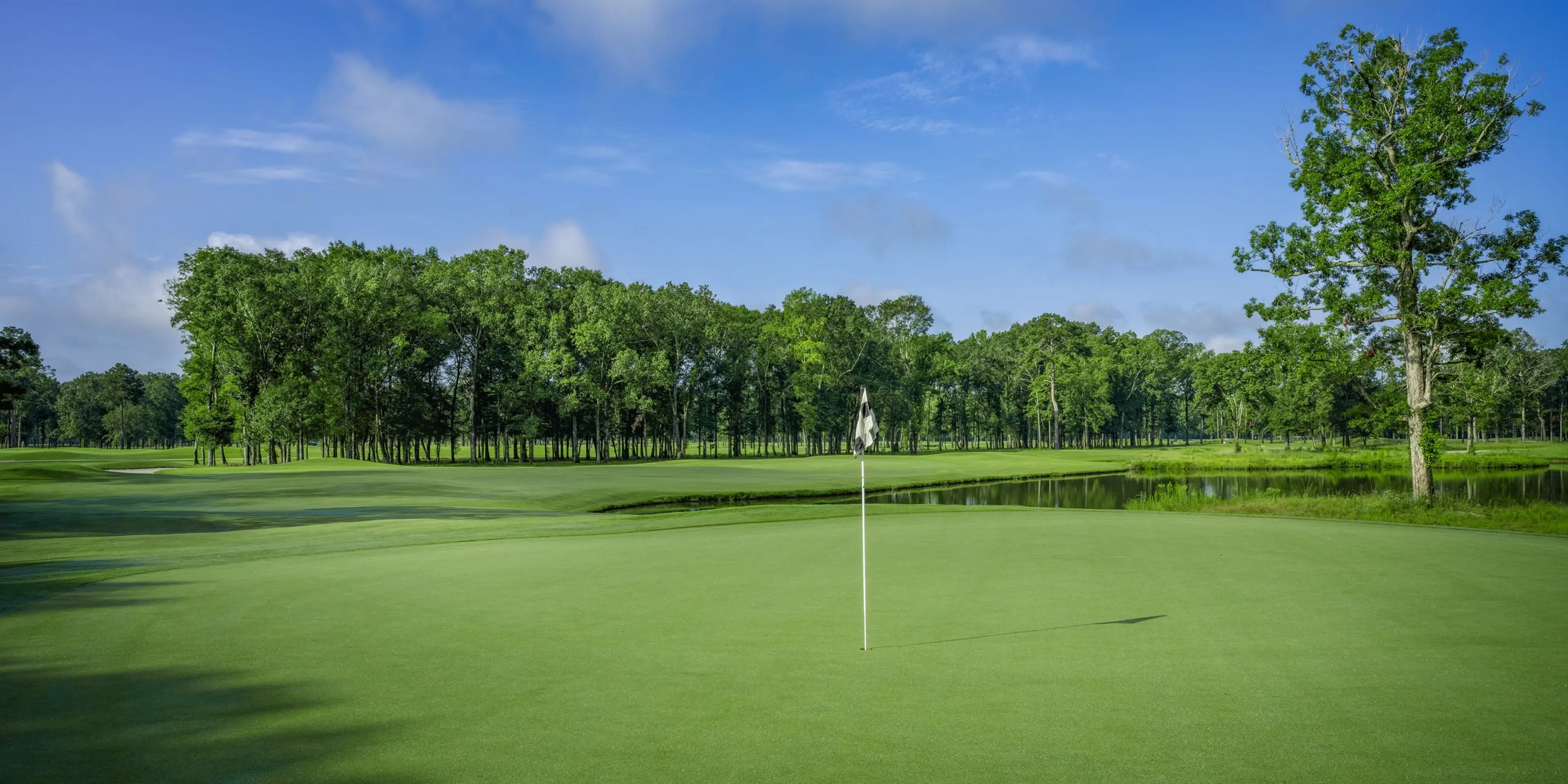 Landscape putting greens and fairway photo of the The Refuge Golf Course golf course