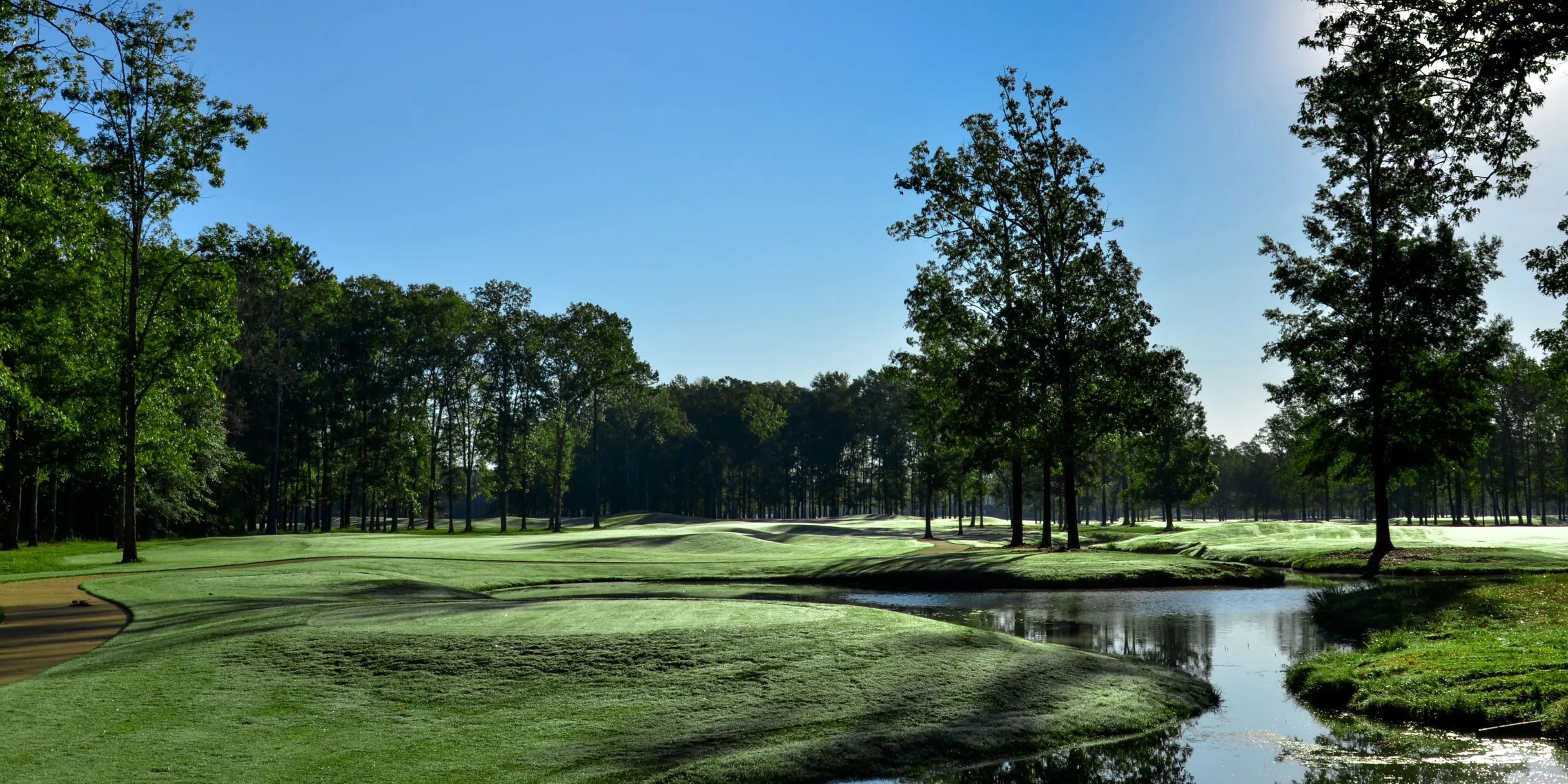 Landscape putting greens and fairway photo of the The Refuge Golf Course golf course