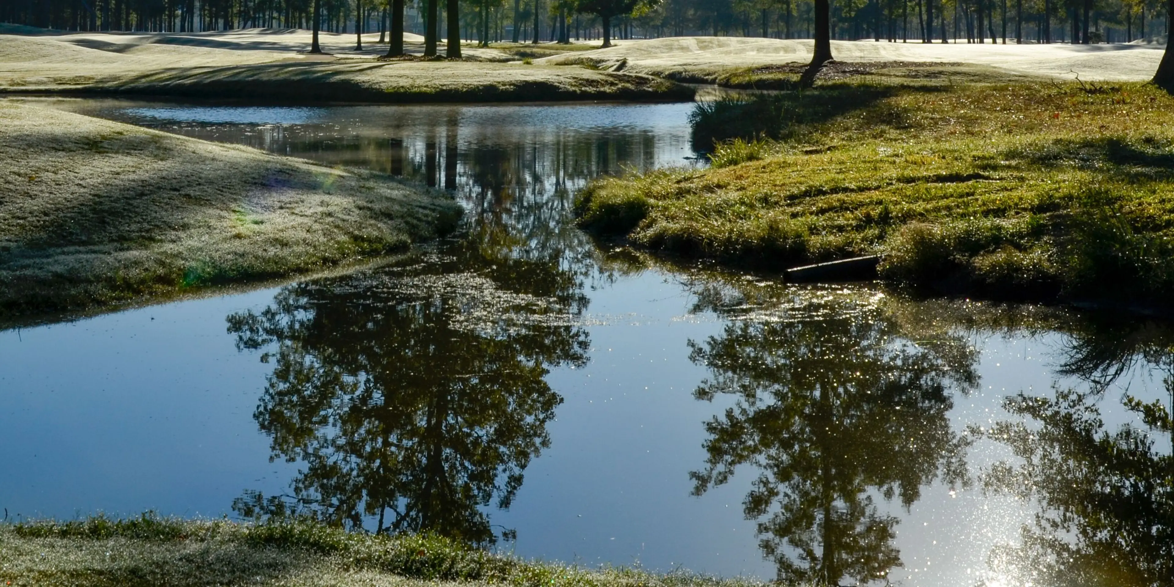 Landscape putting greens and fairway photo of the The Refuge Golf Course golf course