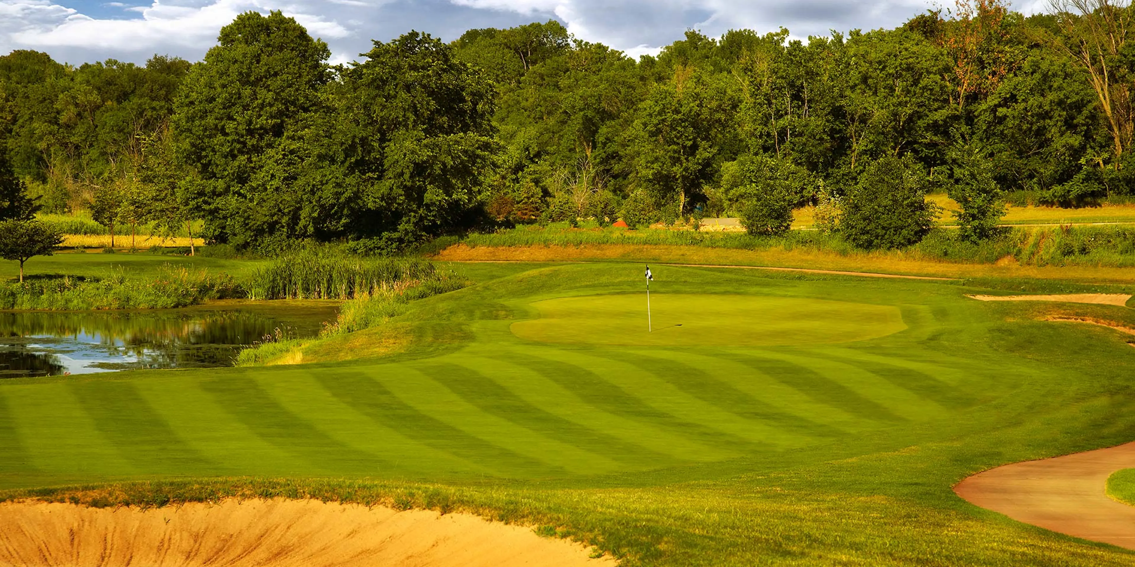 Landscape putting greens and fairway photo of the The Wilds Golf Club golf course